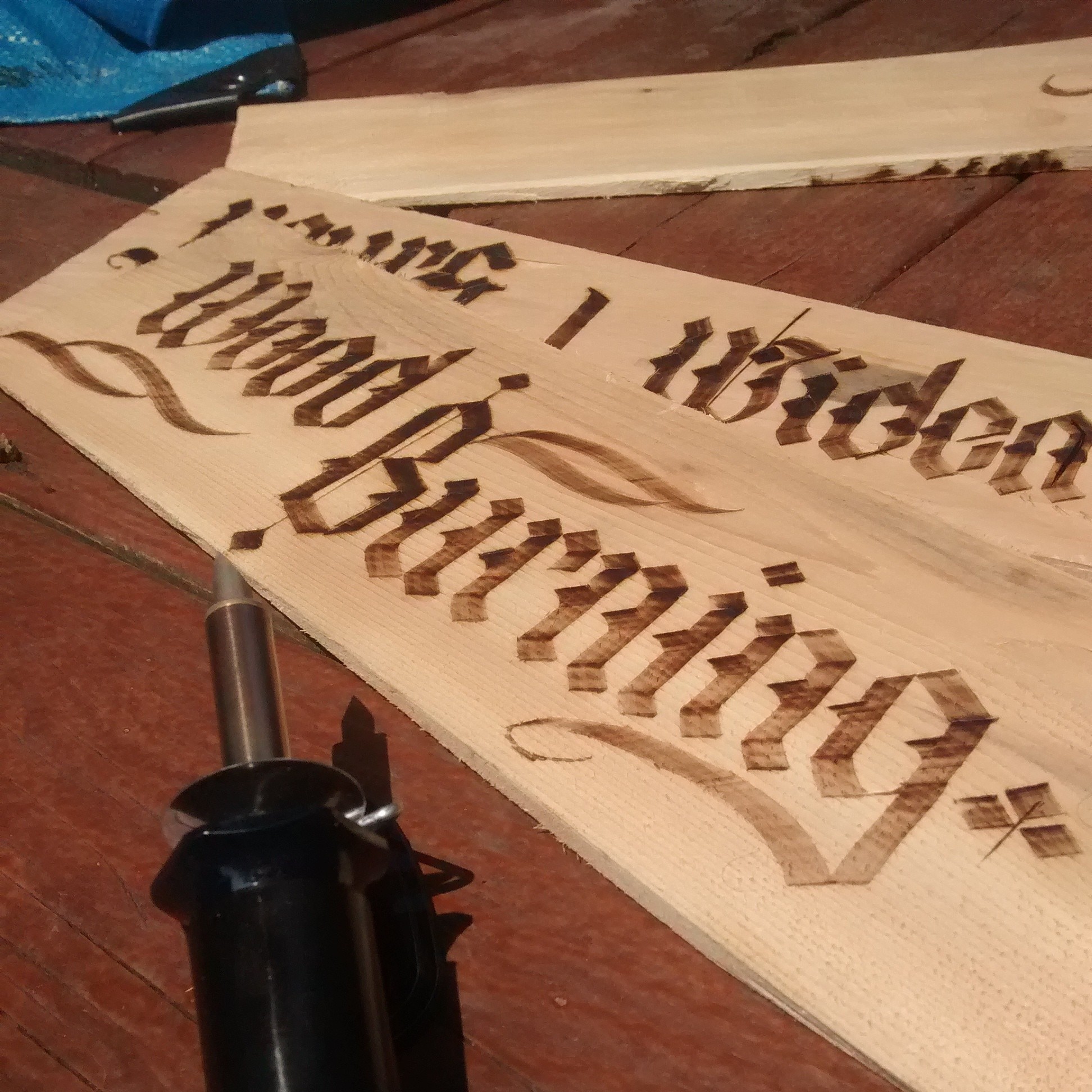 Wood burning calligraphy / pyrography of the words: "wood burning"